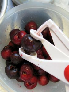 Pitting cherries for Watermelon and Sweet Cherry Salad