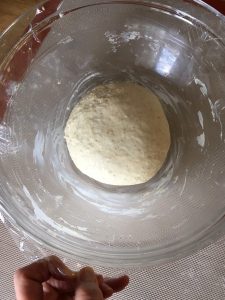 Once the dough feels smooth and springy, place it into a greased bowl.