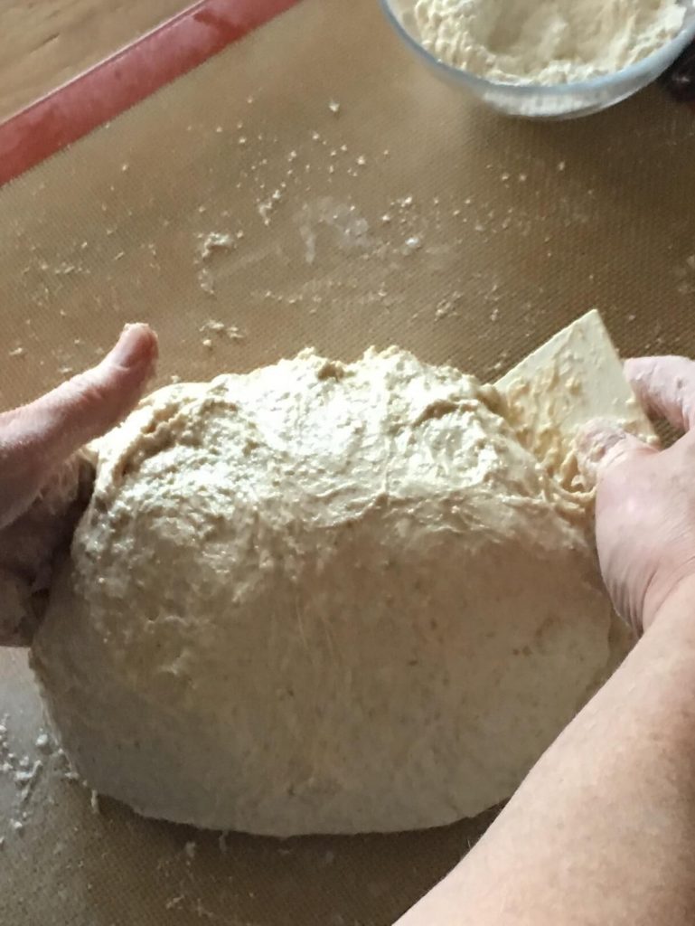 Scrape the dough up and fold onto itself.