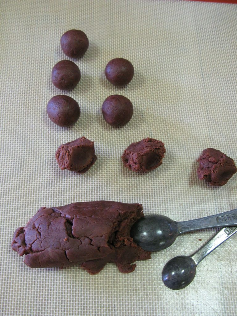 Forming chocolate marzipan into truffles