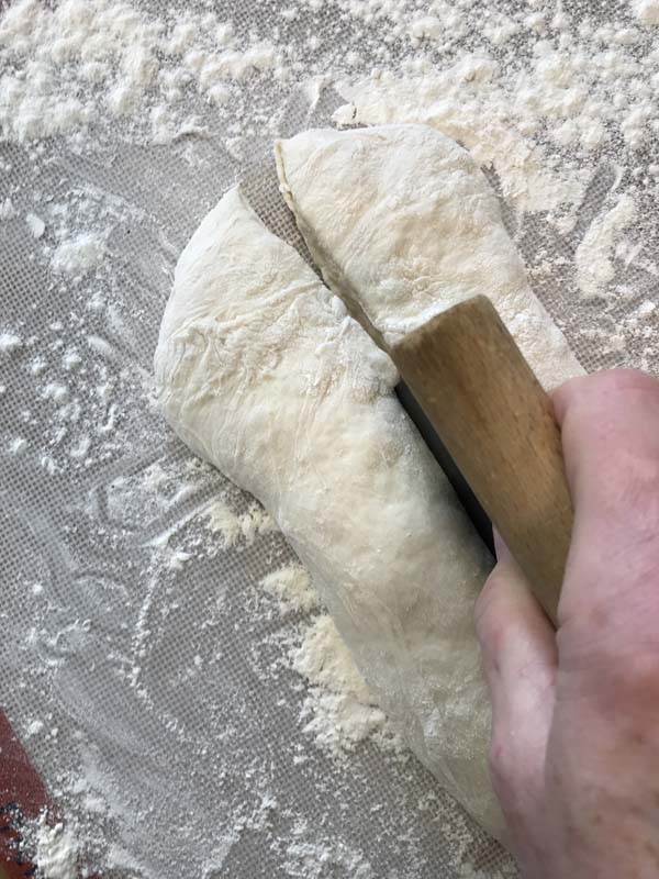 Cutting the soft dough into two long pieces