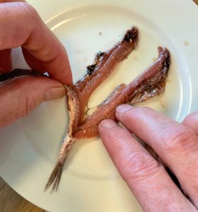 removing the spine of the anchovy